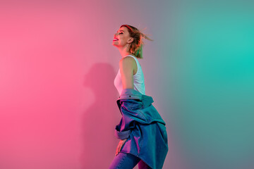 Photo of adorable dreamy lady wear denim jacket enjoying air blowing isolated pink teal gradient color background