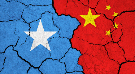 Flags of Somalia and China on cracked surface - politics, relationship concept