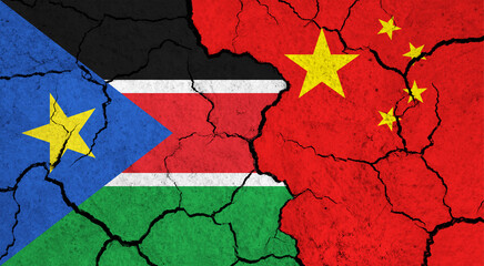 Flags of South Sudan and China on cracked surface - politics, relationship concept