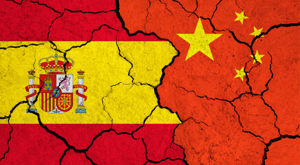 Flags of Spain and China on cracked surface - politics, relationship concept