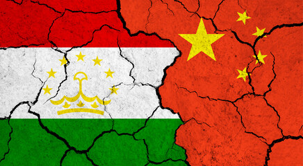 Flags of Tajikistan and China on cracked surface - politics, relationship concept