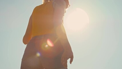 Low angle of three millennial girls in colorful retro clothes rotating on roller skates outside in street at daytime - Powered by Adobe