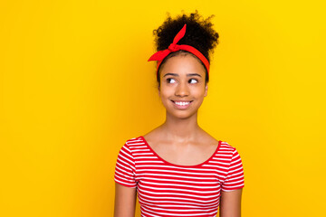 Photo of adorable dreamy girl dressed red striped t-shirt looking empty space isolated yellow color background
