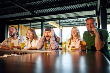 Young people, friends emotionally watching sport match online game, drinking beer, cheering up favourite sport team. Concept of sport competition, hobby, lifestyle, human emotions, fun