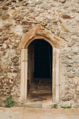 Fototapeta na wymiar Photo of arch entrance, ancient castle interior. Old Arch made of stone