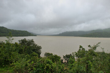 Panoramic landscape view of beautiful scenic Mulshi lake on a cloudy monsoon day. It is a famous tourist spot in Mulshi, Pune, Maharashtra, India
