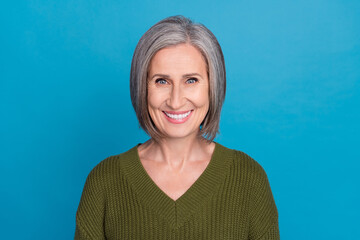Photo of beautiful aged granny beaming smiling demonstrating white teeth wear khaki sweater isolated blue color background