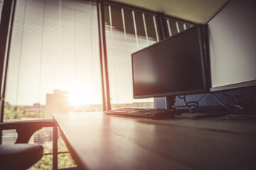 Empty desk during sunset. Corporate office theme.