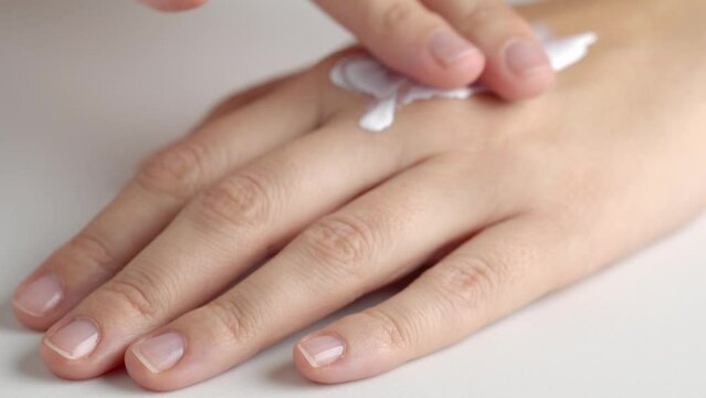 Applying SPF sunscreen cream or sun tanning lotion on skin, macro. Skin Protection concept. Protective Cream Cosmetic.