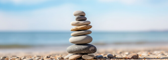Some stones are stacked on a beautiful seaside sandy beach