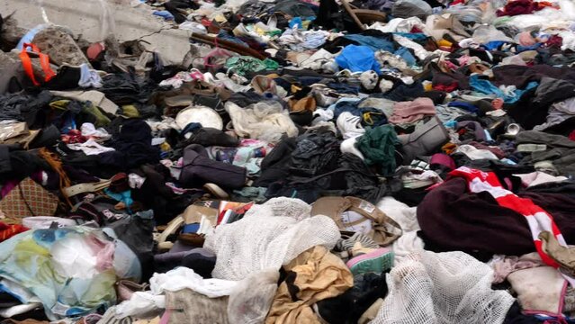 Mountains of discarded old clothes. Oversupply of production in the consumer market.