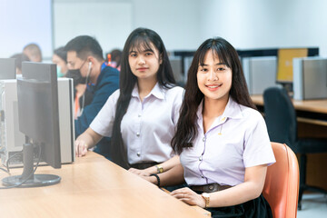 Asian college students studying in computer classroom