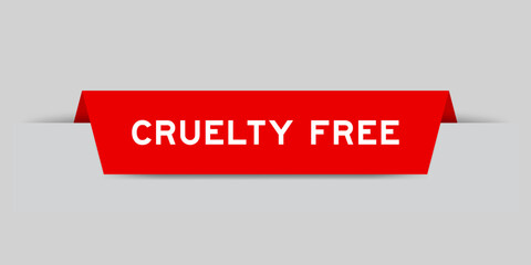 Red color inserted label with word cruelty free on gray background