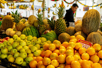 fruit market in porto portugal with colorful products apple orange Aproveite means Enjoy it