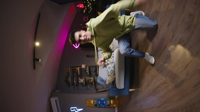 Asian boy recording video of trending hip hop dance challenge for likes and followers on social media platform, vertical video. Concept of virtual life, social media communication tik tok reels