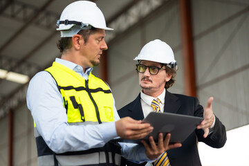 Caucasian construction architect Engineering man and busines owner in safety hardhat working at precast factory industrial. Heavy Industry Manufacturing Factory. Prefabricated concrete walls