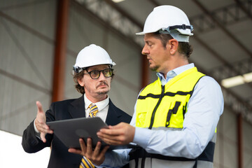 Fototapeta premium Caucasian construction architect Engineering man and busines owner in safety hardhat working at precast factory industrial. Heavy Industry Manufacturing Factory. Prefabricated concrete walls