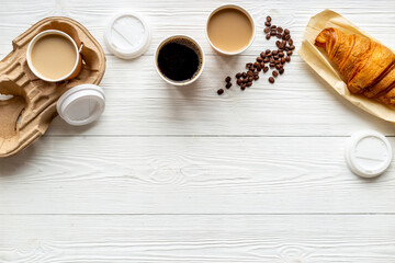 Different types of coffee in paper cup with croissant
