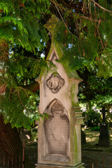 schöne alte Grabsäule unter einem Baum auf einem alten Friedhof in Roermond