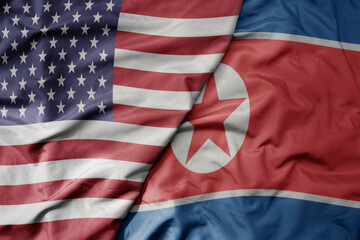 big waving colorful flag of united states of america and national flag of north korea .