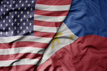 Obraz premium big waving colorful flag of united states of america and national flag of philippines .