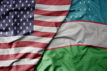Obraz premium big waving colorful flag of united states of america and national flag of uzbekistan .