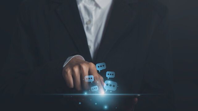 Live Chat on tablet Businessman hand typing conversation show chat message box talking or comment icons  pop up on application Communication Digital Web and social network.