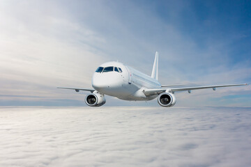 Fototapeta na wymiar Modern white passenger jetliner flying in the sky above the clouds