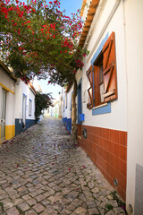 Narrow cobblestone streets and typical portuguese facades in Ferragudo town