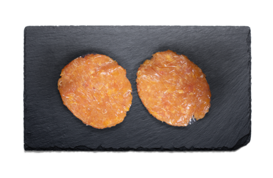 Raw chicken burgers on a slate plate from above with a semitransparent shadow - Powered by Adobe