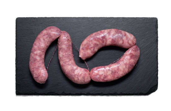 raw spanish criollo chorizo on a slate plate from above with a semitransparent shadow