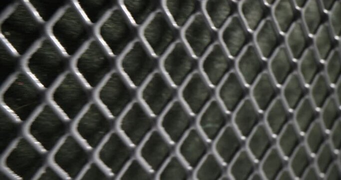 Grey perforated metal mesh as fence of private territory and housing. Concept of square grid pattern and texture as seamless design element