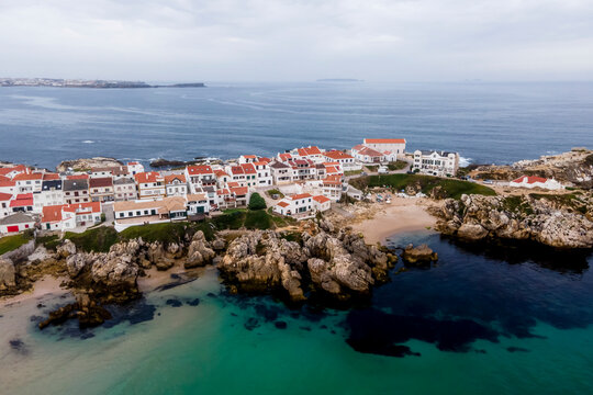 Aerial view of Praia dos Barcos, a small inlet with beach along the coastline in Baleal, a small town on island in Leiria, Portugal.