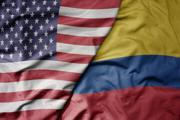 Obraz premium big waving colorful flag of united states of america and national flag of colombia .