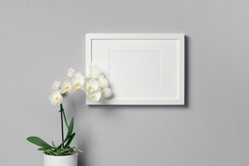 Blank landscape picture frame mockup with white orchid flower