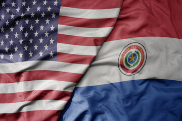 big waving colorful flag of united states of america and national flag of paraguay .
