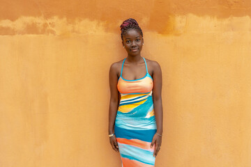 Young lady in dress standing on empty walkway