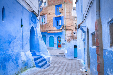 Blue shade of houses, street and alley in Chefchaouen, a city in northwest Morocco where is noted...