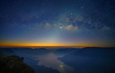 Milky Way. Colorful night landscape with bright milky way, starry sky and hills in summer. Milky Way over the mountain peaks.