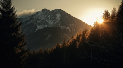 Mountain at sunset with sun and forest.
