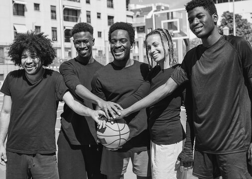 Happy african people stacking hands on baket ball after match - Young friends and sport concept