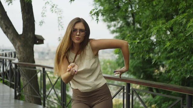 On the observation deck, a girl dances with sheer elegance, her movements echoing the dynamic cityscape that surrounds her. High quality 4k footage