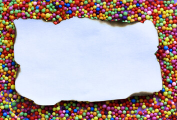 Vintage old paper page with burnt edges flatly. Bright foam multi-colored balls on a purple background. White frame with space for text top view. Note for a message. Invitation letter. Greeting card.