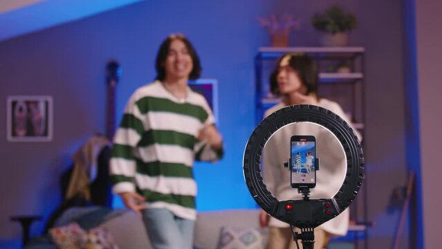 Multiethnic bloggers dancers record videos. Masterpiece dance performance of Asian guys who become real stars of social networks and get stormy rush of likes. Talent, passion, charisma of male dancers