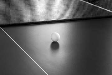 Tennis ball on the table. Black and white image. - obrazy, fototapety, plakaty