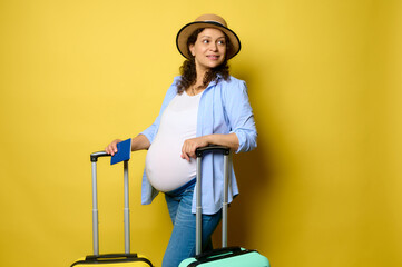 Smiling curly haired Latin pregnant woman going for summer getaway, travelling abroad, isolated...