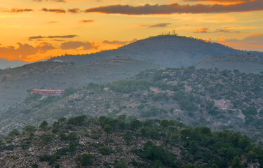 Mountains landscape on sunset. Mountain view from Mola De Segart mountain in Sierra Calderona...