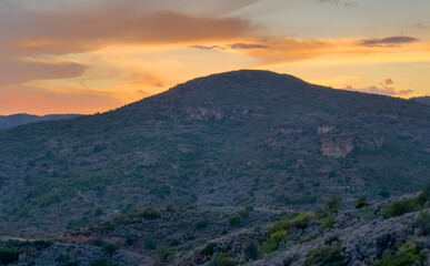 Mountains landscape on sunset. Mountain view from Mola De Segart mountain in Sierra Calderona national park in Valencia, Spain. Sunset over mountains. Landscape of a mountain valley. Hill on sunrise.