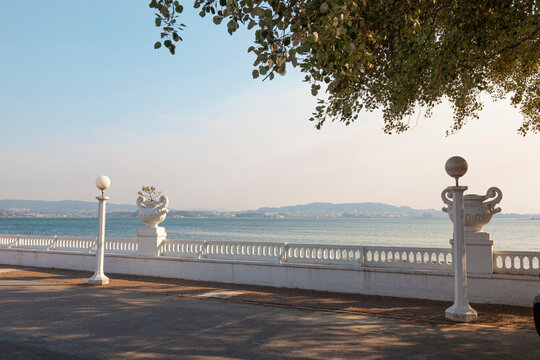 Island of La Toja, Ria de Aurosa, Galicia. Empty walkway and snow-white retro balustrade with beautiful vases of flowers.