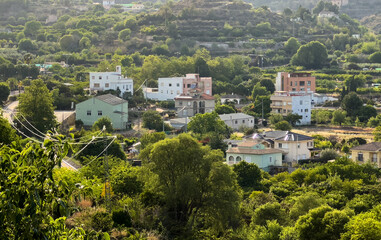 Rural landscape in Segorbe, aerial view. Farmhouse in vegetable garden on farmland. Cultivation of crops, production of food in countryside. Sowing grain and harvesting on field. House in farm field.